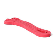 Element Fitness red strength band coiled on white background
